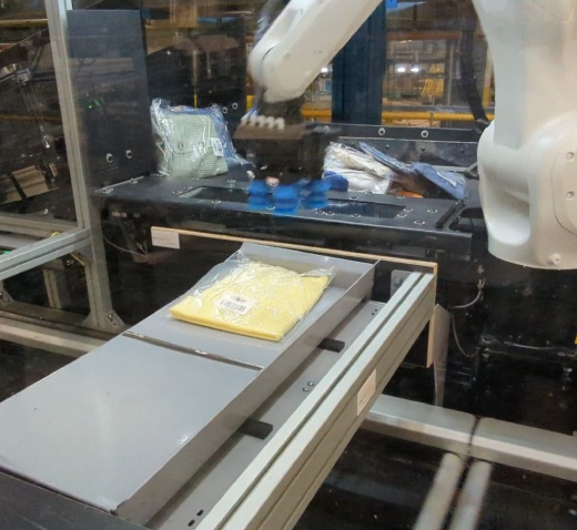 Synchronised Tilting Table being filled with a robotic arm